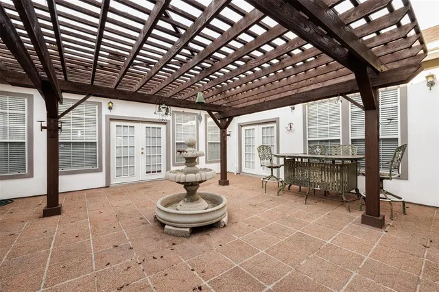 a table and chairs with wooden fence