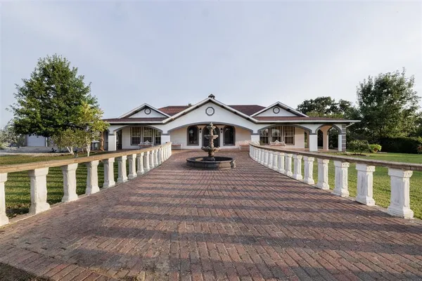 a view of a house with wooden floor and a yard