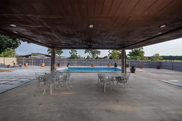 a house view with swimming pool and sitting space