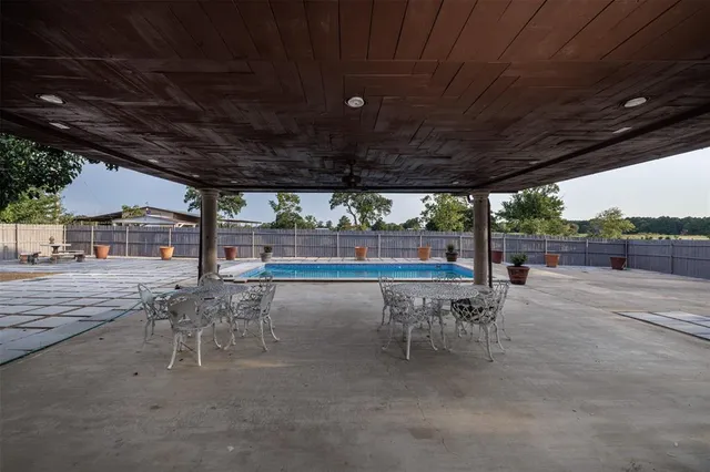 a house view with swimming pool and sitting space