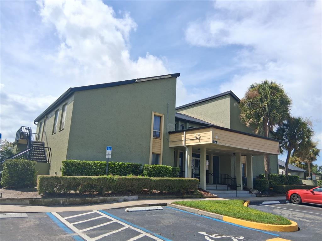 958 Lake Destiny Road, Unit D Altamonte Springs, FL 32714 - Photo 12 of 16 a front view of a house with a yard and palm trees