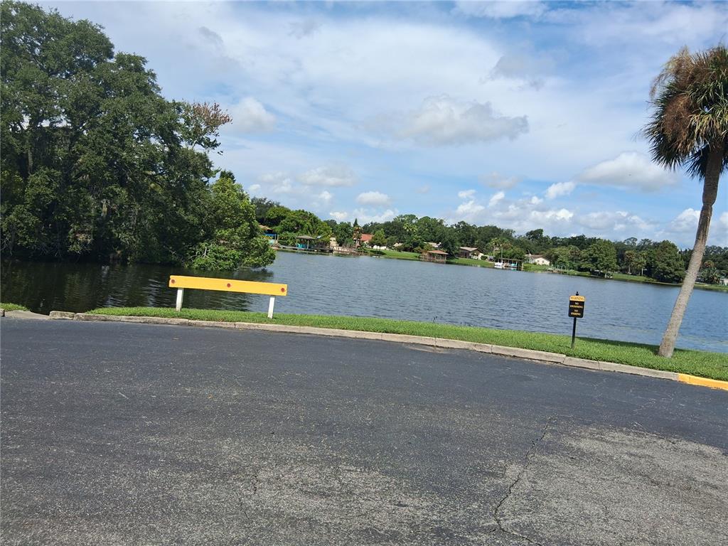 958 Lake Destiny Road, Unit D Altamonte Springs, FL 32714 - Photo 13 of 16 a view of a lake with a swimming pool and a yard