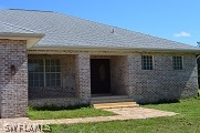 21951 Claytor Road Alva, FL 33920 - Photo 1 of 17 a front view of a house with a yard