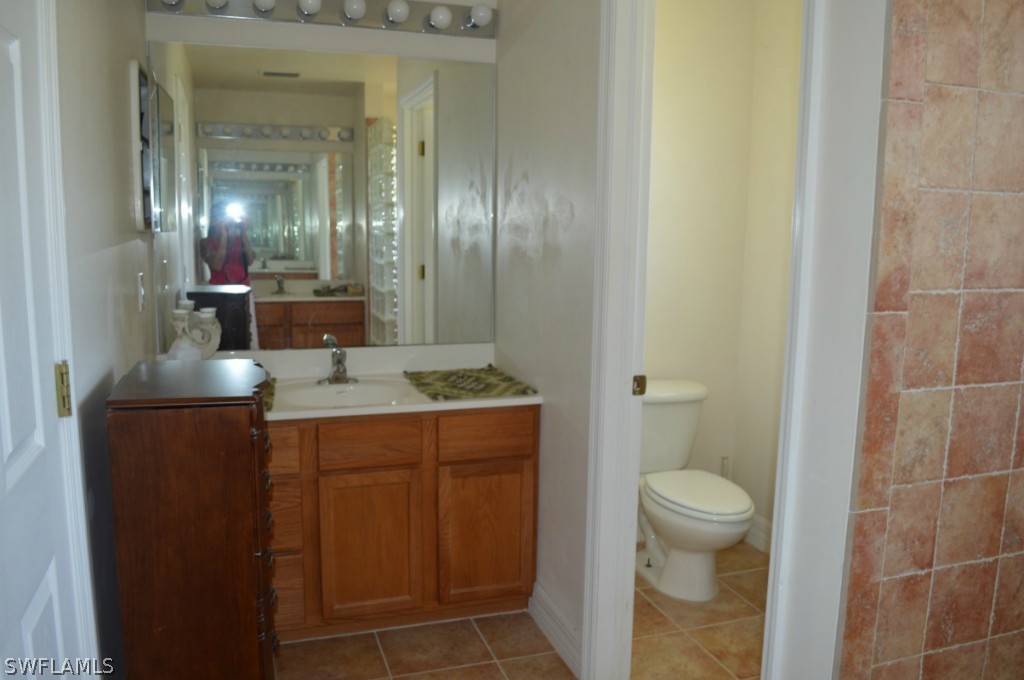 21951 Claytor Road Alva, FL 33920 - Photo 13 of 17 a bathroom with a sink a toilet and shower