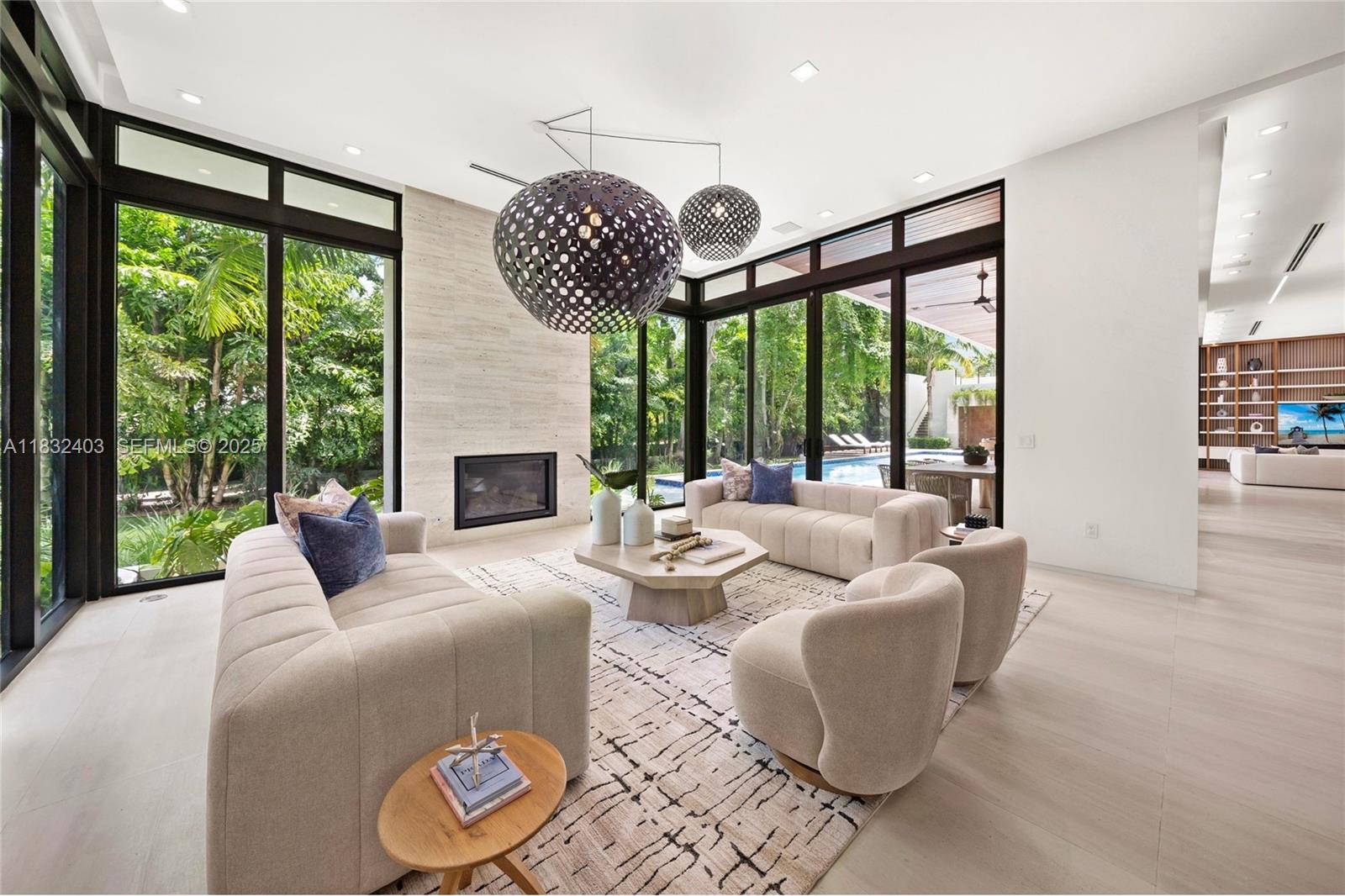 7610 Southwest 48th Court Miami, FL 33143 - Photo 2 of 34 a living room with patio fireplace furniture and a large window