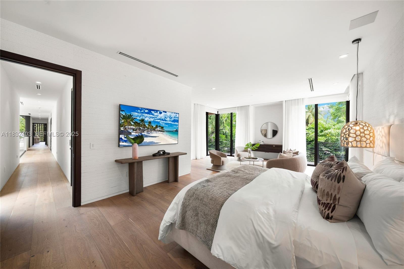 7610 Southwest 48th Court Miami, FL 33143 - Photo 21 of 34 a spacious bedroom with a large bed and a chandelier