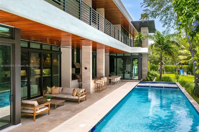 swimming pool view with a seating space