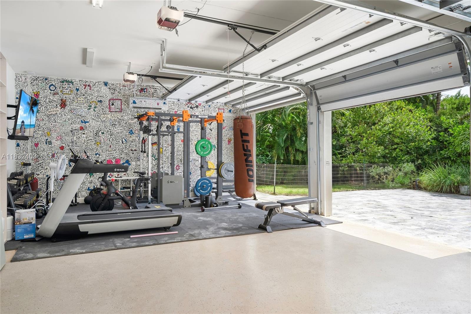 7610 Southwest 48th Court Miami, FL 33143 - Photo 31 of 34 a view of garage with furniture and a floor to ceiling window