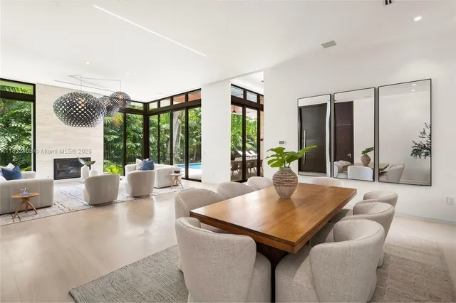 a living room with furniture and large windows