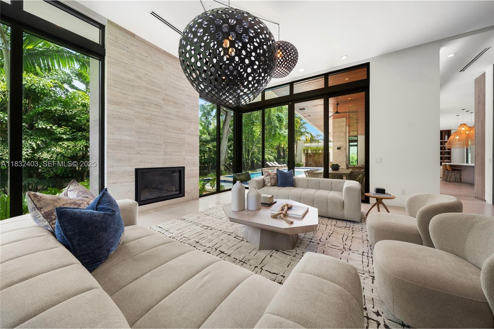 7610 Southwest 48th Court Miami, FL 33143 - Photo 10 of 34 a living room with furniture a fireplace and a large window