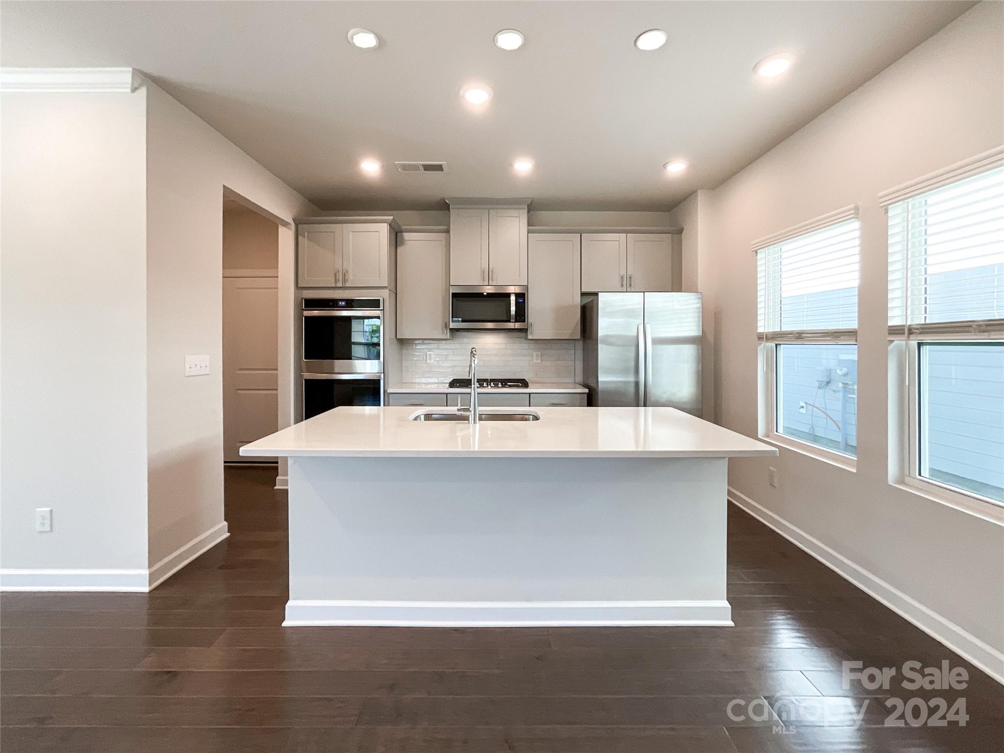 137 Cedar Knoll Circle Pineville, NC 28134 - Photo 12 of 48 a view living room with stainless steel appliances wooden floor and large window