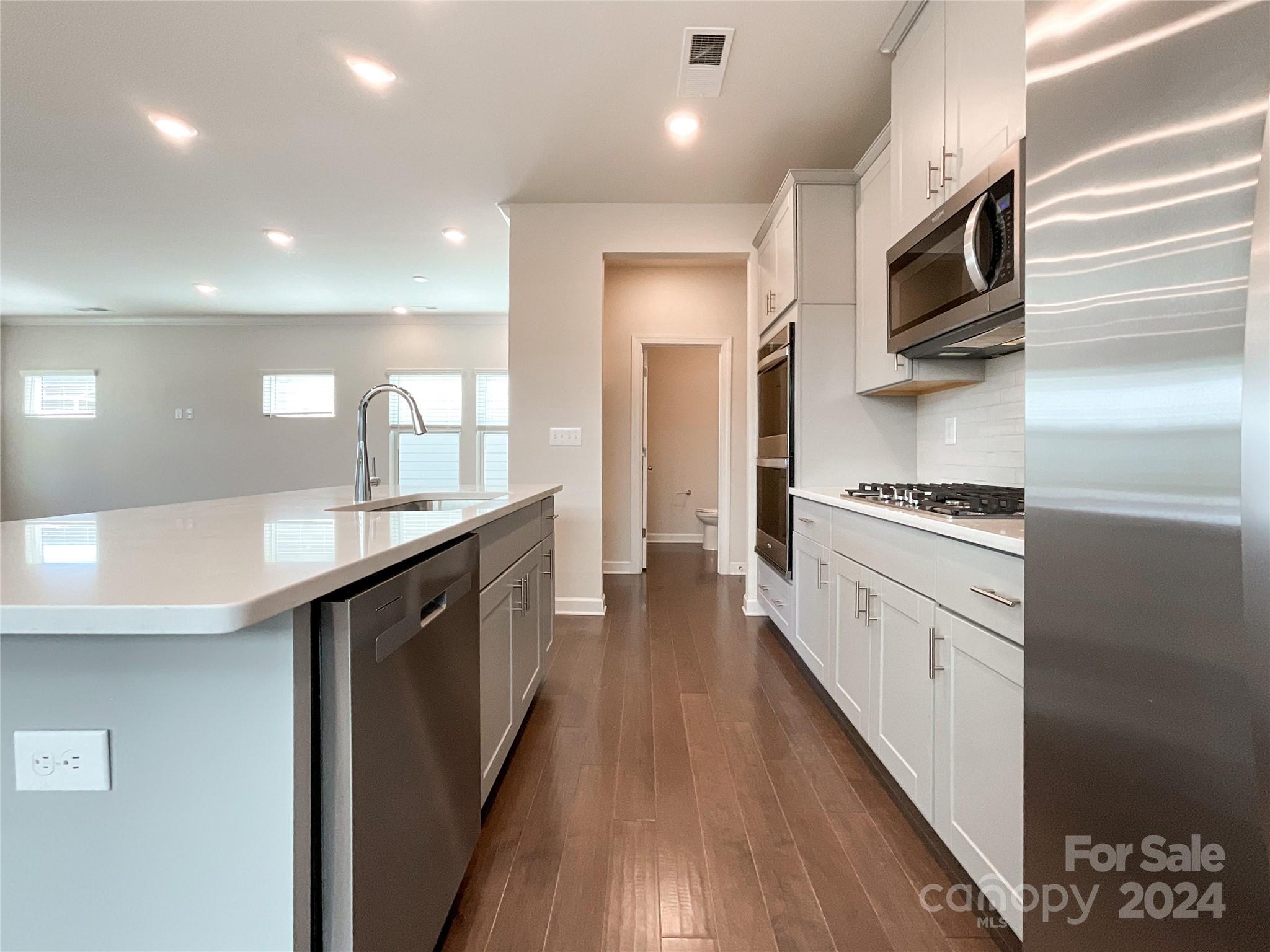 137 Cedar Knoll Circle Pineville, NC 28134 - Photo 13 of 48 a large kitchen with stainless steel appliances