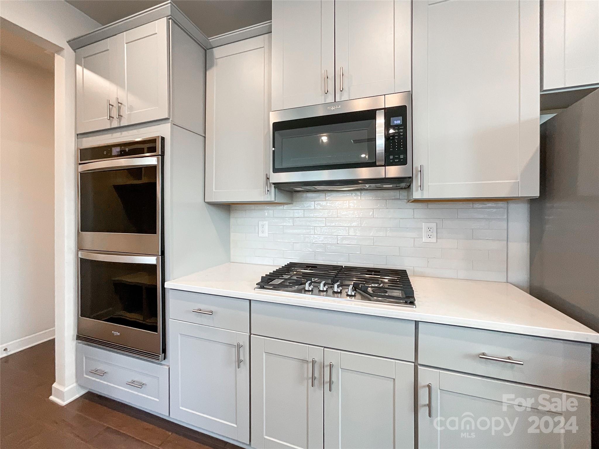137 Cedar Knoll Circle Pineville, NC 28134 - Photo 14 of 48 a kitchen with stainless steel appliances white cabinets and stove