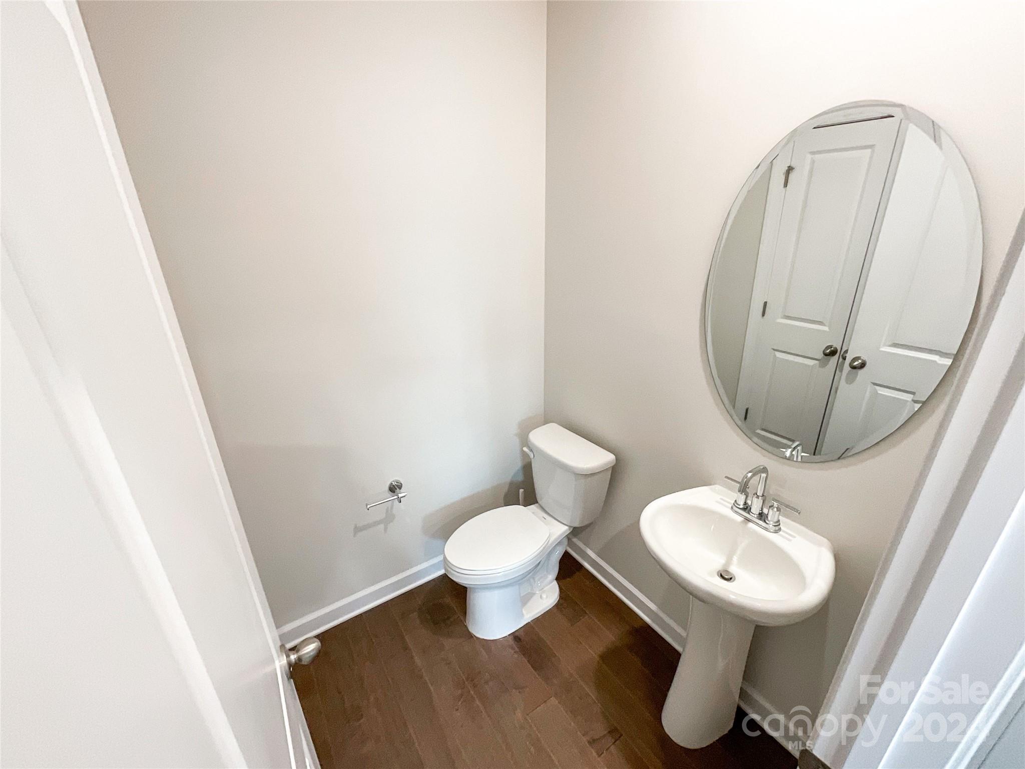 137 Cedar Knoll Circle Pineville, NC 28134 - Photo 19 of 48 a bathroom with a toilet sink and a mirror