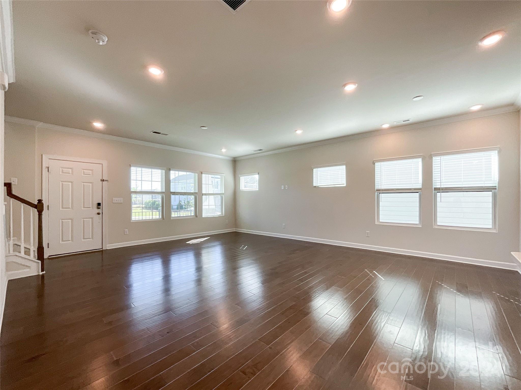137 Cedar Knoll Circle Pineville, NC 28134 - Photo 2 of 48 a view of an empty room with wooden floor and a window