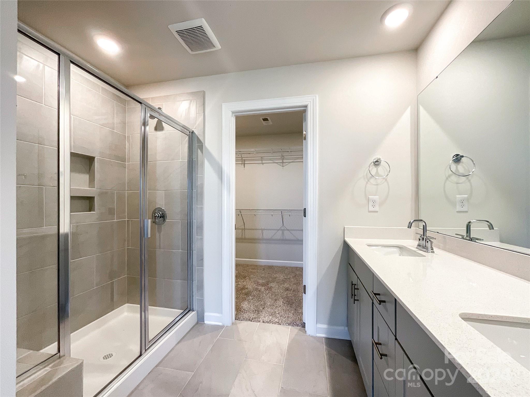 137 Cedar Knoll Circle Pineville, NC 28134 - Photo 28 of 48 a bathroom with a shower sink and mirror