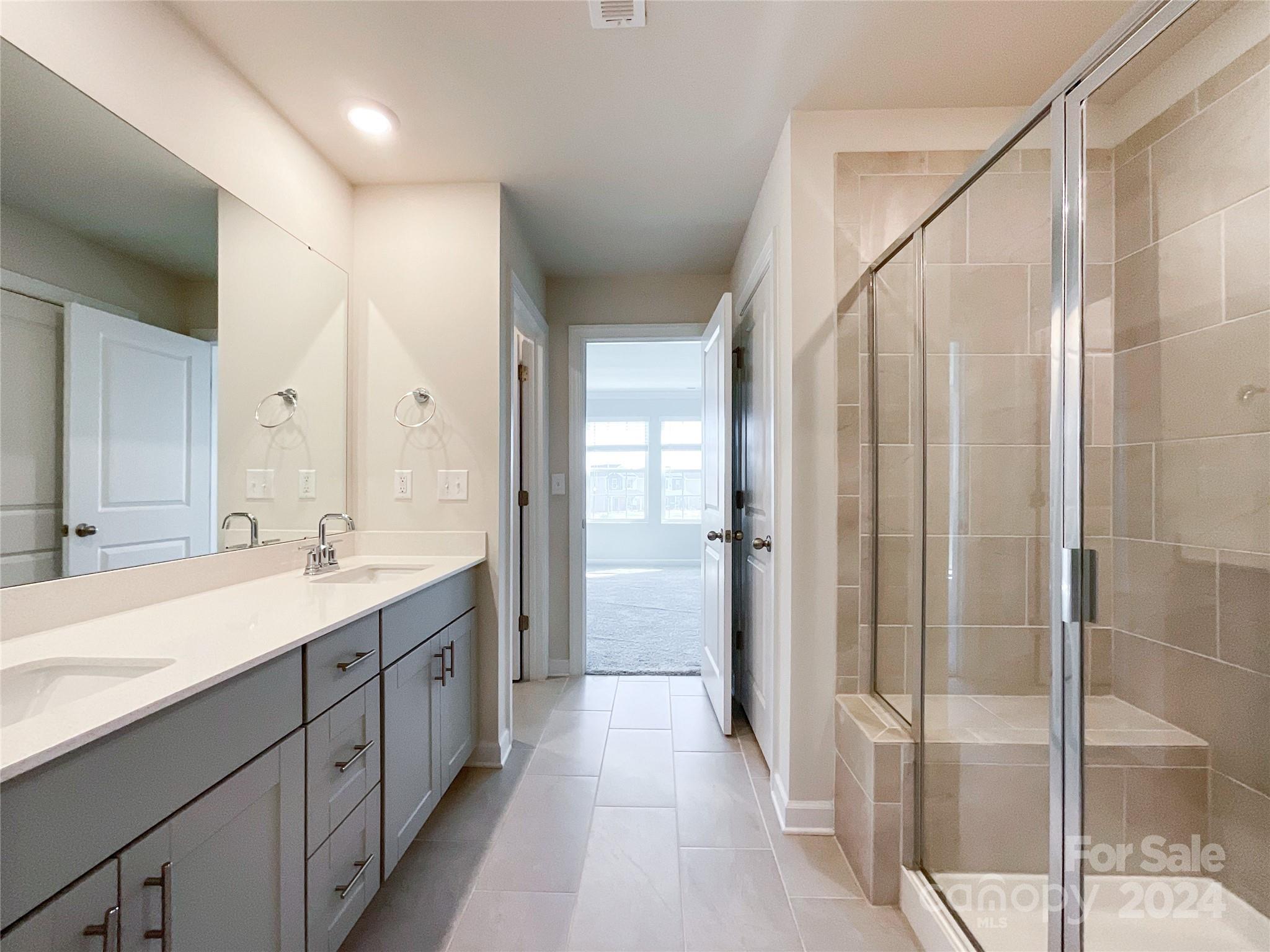 137 Cedar Knoll Circle Pineville, NC 28134 - Photo 29 of 48 a spacious bathroom with a double vanity sink mirror and shower