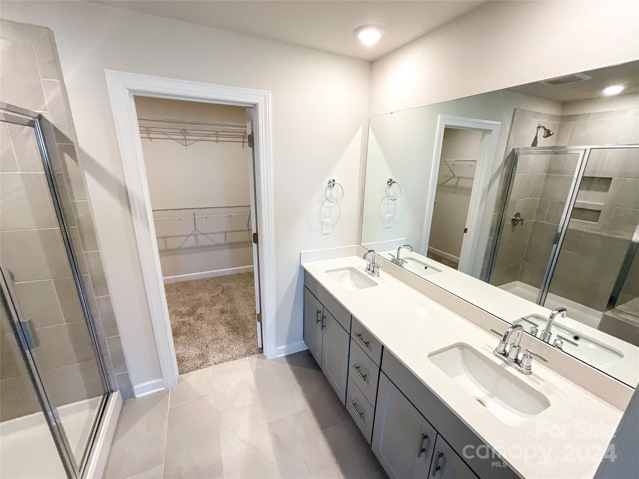 137 Cedar Knoll Circle Pineville, NC 28134 - Photo 30 of 48 a bathroom with a double vanity sink a and mirror