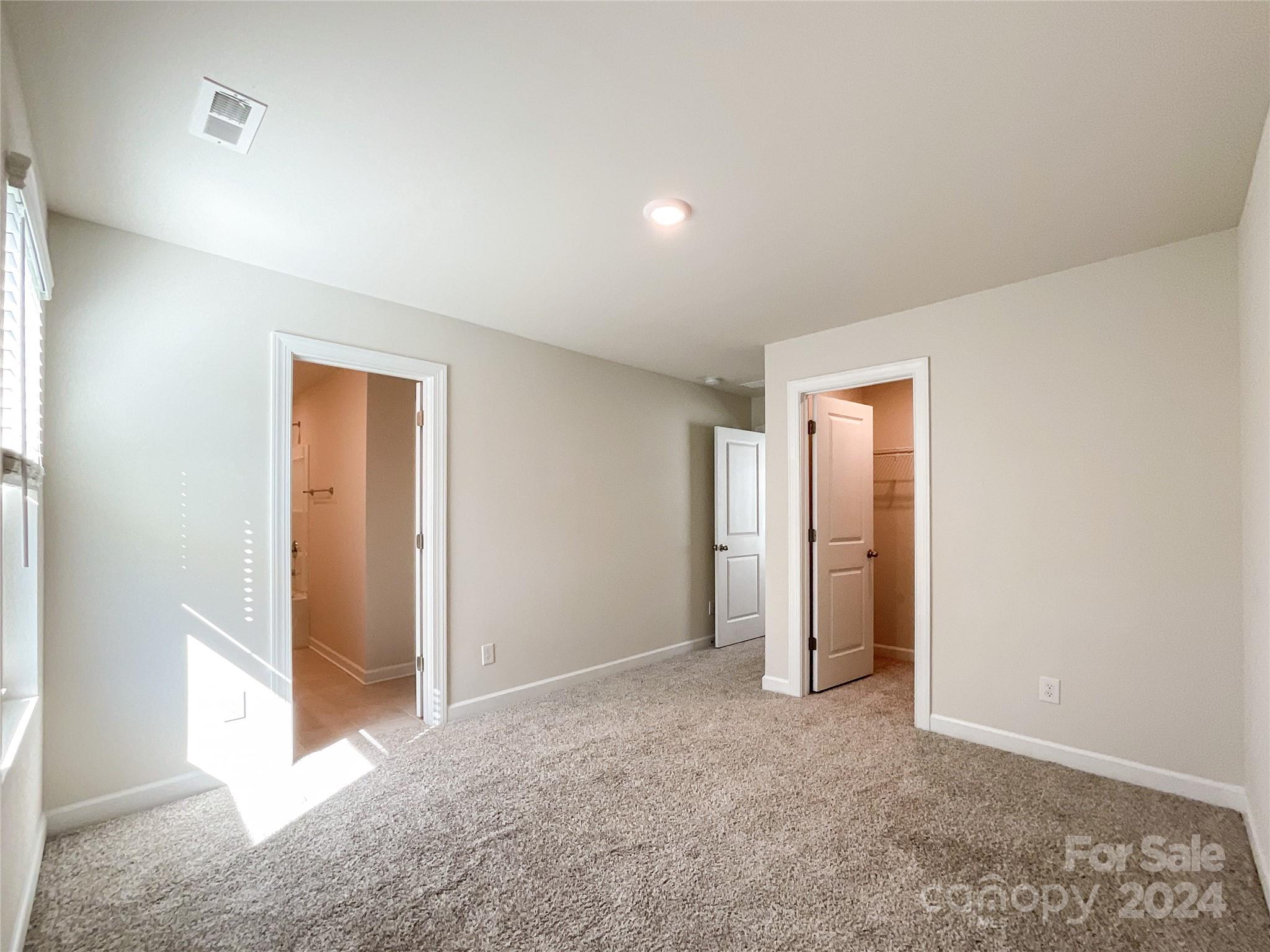 137 Cedar Knoll Circle Pineville, NC 28134 - Photo 36 of 48 an empty room with closet and windows