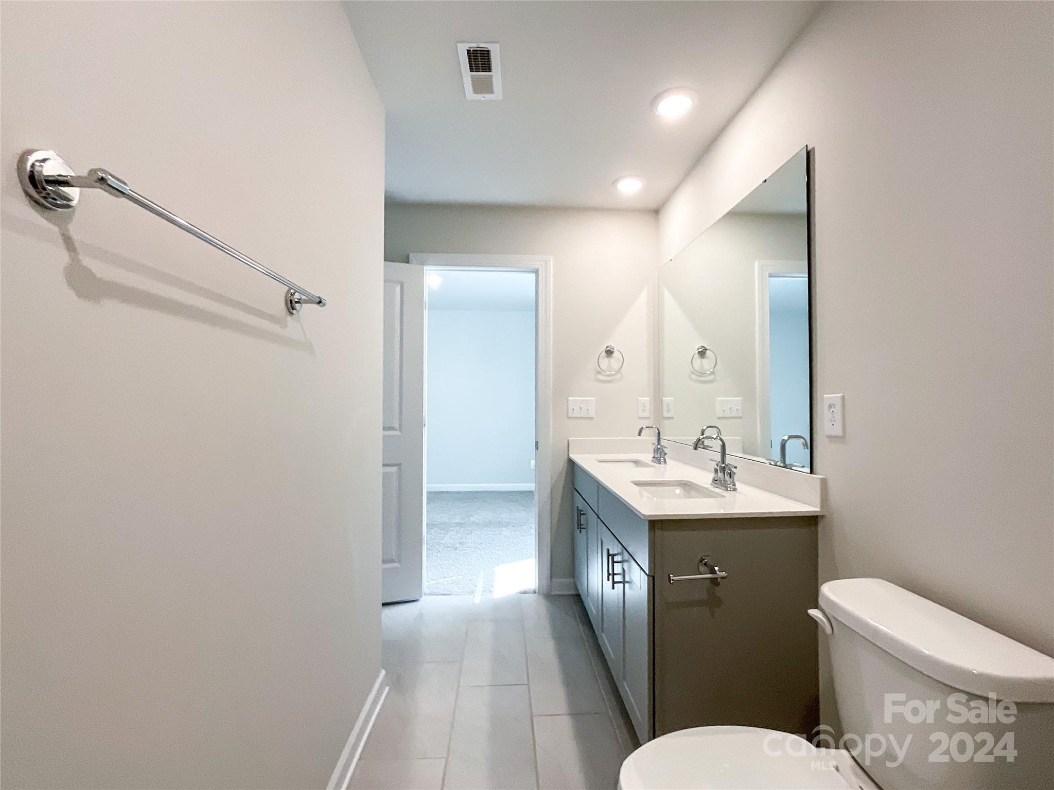 137 Cedar Knoll Circle Pineville, NC 28134 - Photo 42 of 48 a bathroom with a toilet a sink and mirror