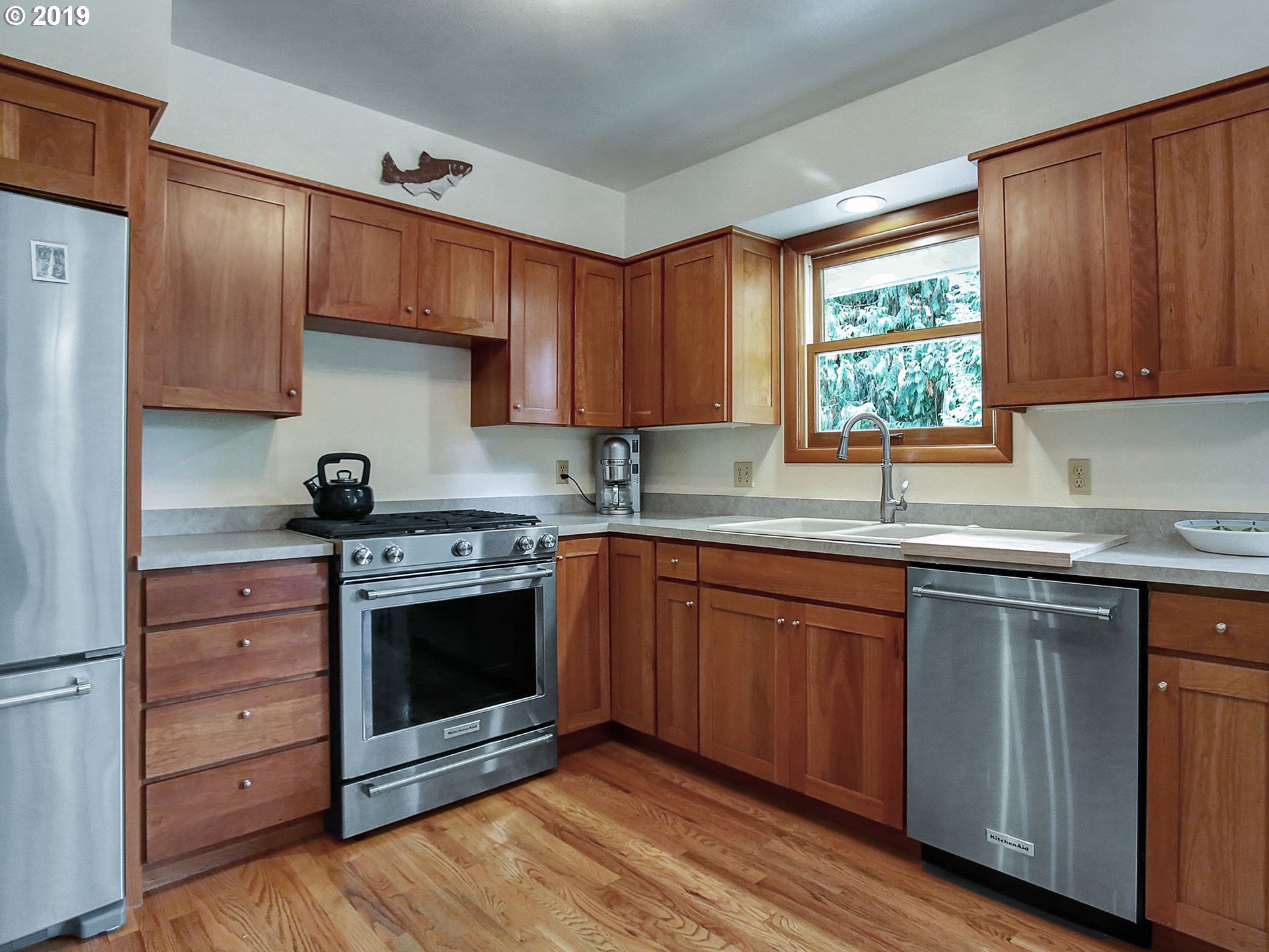4119 Southwest Hamilton Street Portland, OR 97221 - Photo 3 of 29 a kitchen with stainless steel appliances granite countertop a sink stove and cabinets