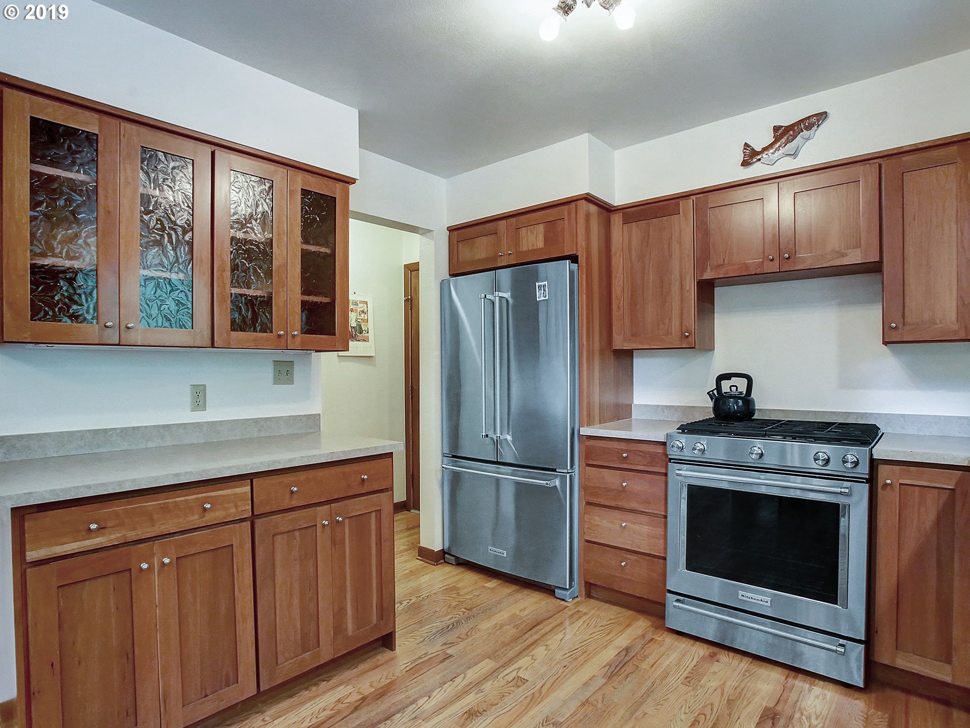 4119 Southwest Hamilton Street Portland, OR 97221 - Photo 4 of 29 a kitchen with stainless steel appliances granite countertop a stove a refrigerator and a cabinets