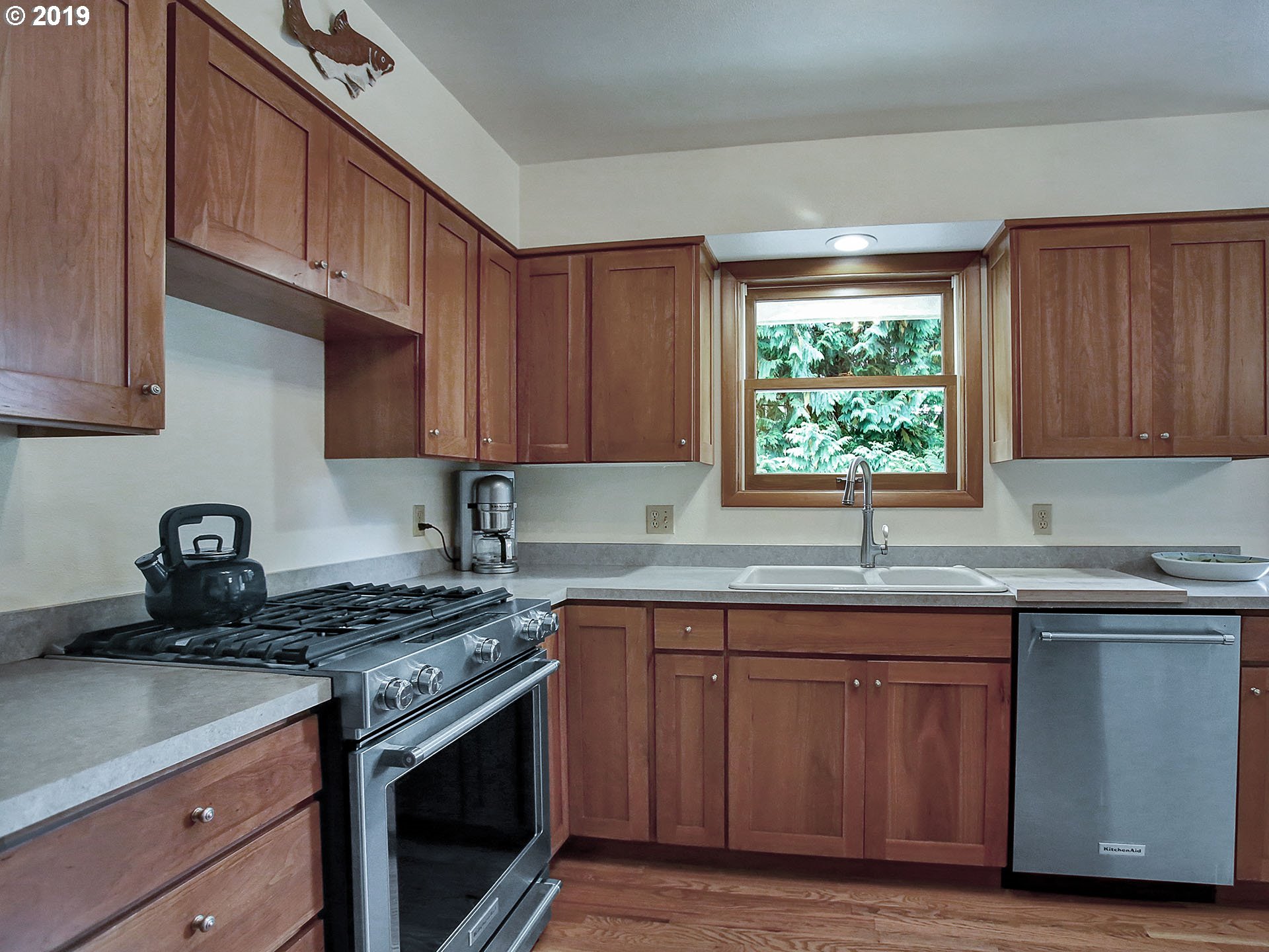 4119 Southwest Hamilton Street Portland, OR 97221 - Photo 5 of 29 a kitchen with stainless steel appliances granite countertop a sink stove and cabinets