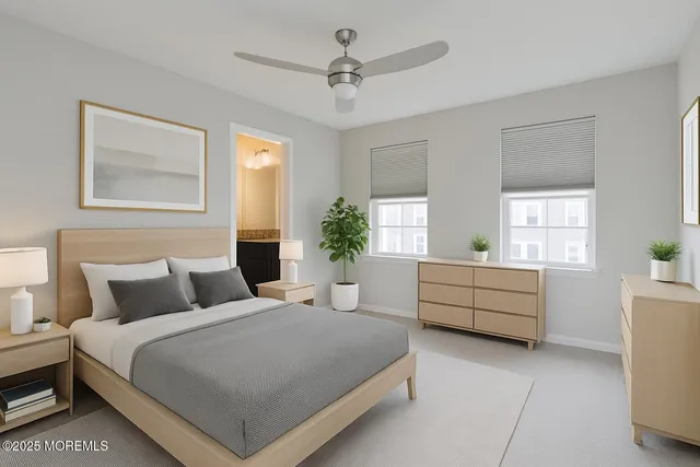 a bedroom with a large bed and windows