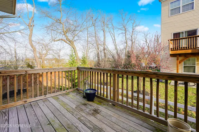 a balcony with wooden floor and fence