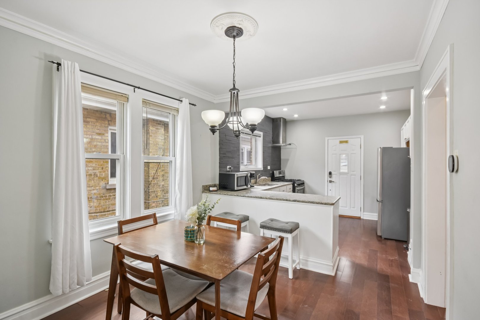 2928 North Rutherford Avenue Chicago, IL 60634 - Photo 4 of 25 a view of a dining room with furniture window and wooden floor