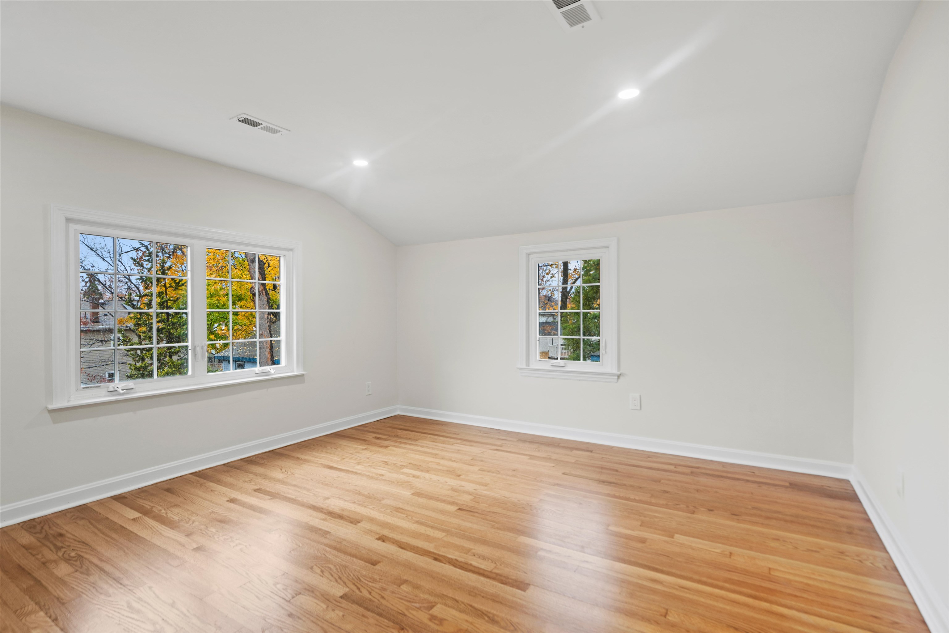 238 Springfield Avenue, Unit 2 Rutherford, NJ 07070 - Photo 4 of 21 a view of an empty room with wooden floor and a window