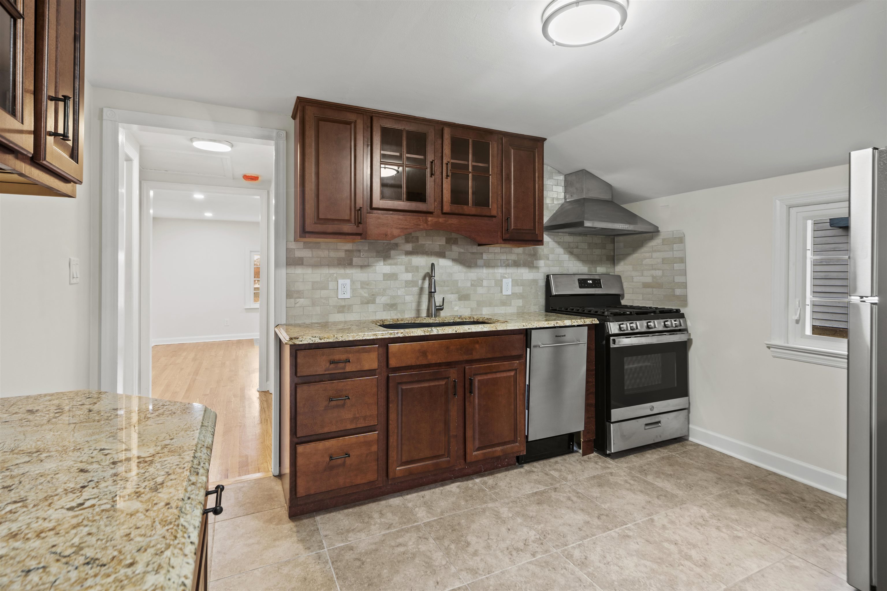 238 Springfield Avenue, Unit 2 Rutherford, NJ 07070 - Photo 6 of 21 a kitchen with stainless steel appliances granite countertop a stove and a sink