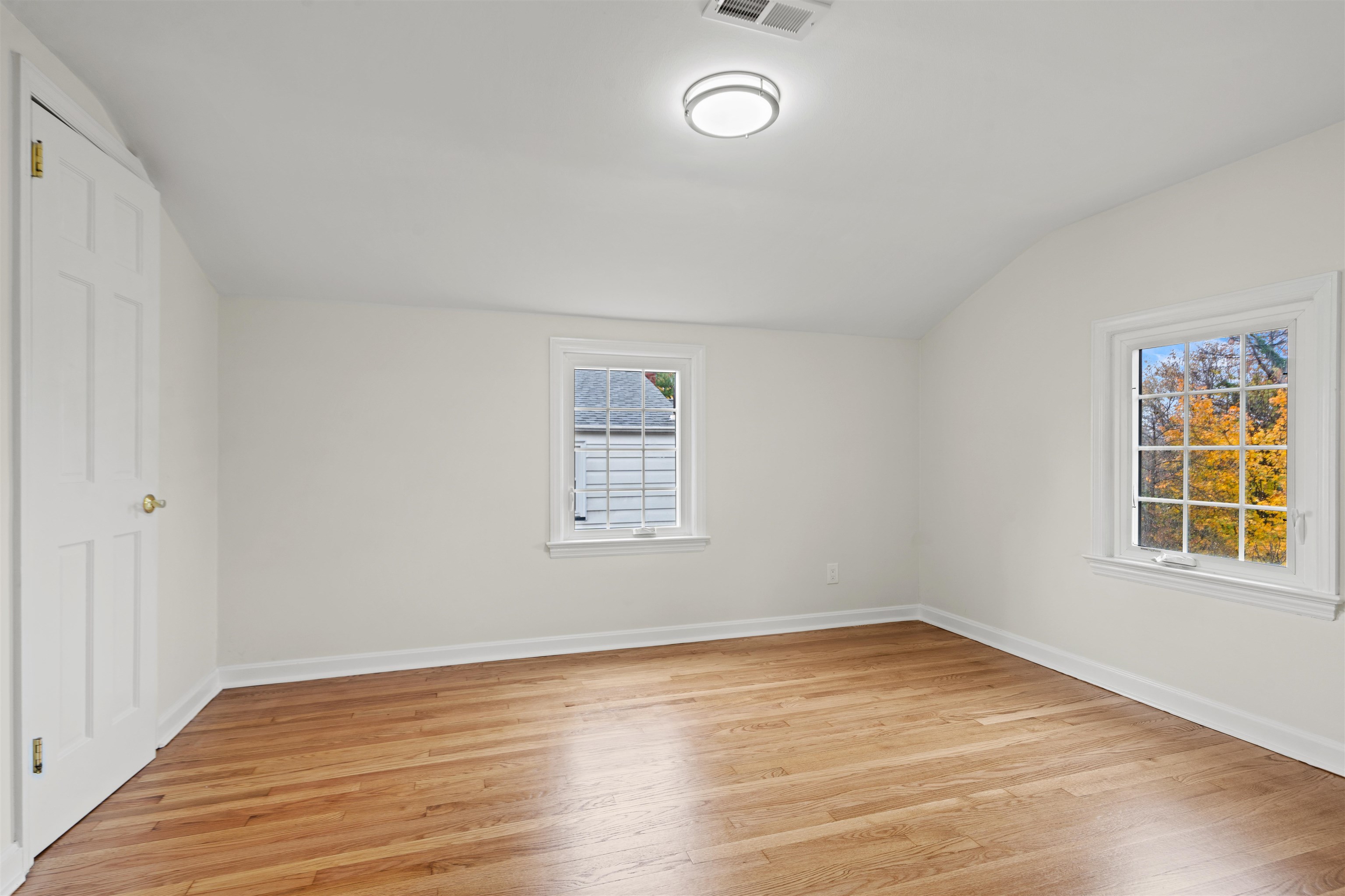 238 Springfield Avenue, Unit 2 Rutherford, NJ 07070 - Photo 10 of 21 an empty room with wooden floor and windows