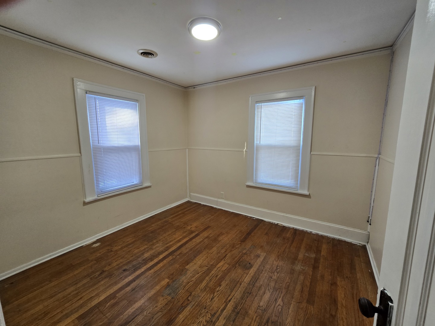 616 West Keith Avenue Waukegan, IL 60085 - Photo 12 of 19 a view of an empty room with wooden floor and a window