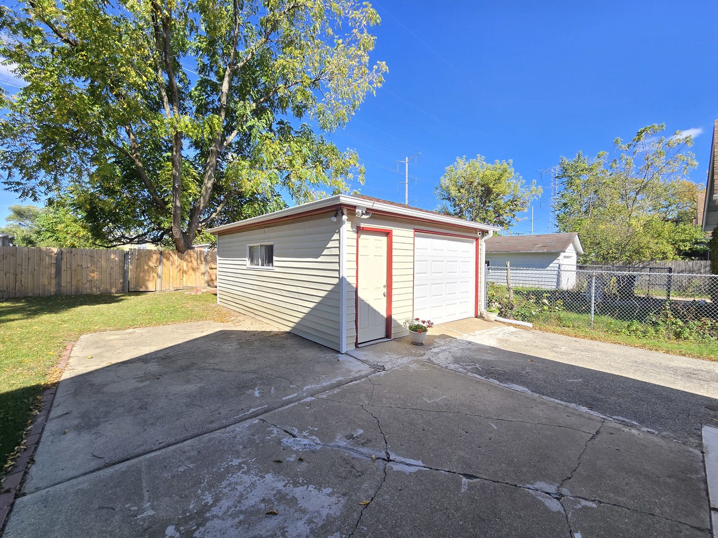 616 West Keith Avenue Waukegan, IL 60085 - Photo 18 of 19 a view of a house with a backyard and a garage