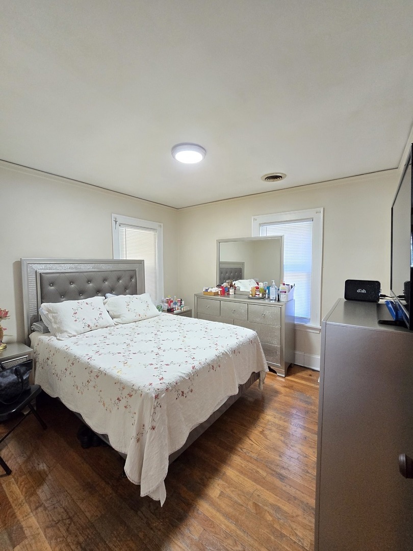 616 West Keith Avenue Waukegan, IL 60085 - Photo 5 of 19 a bedroom with a bed and a large window