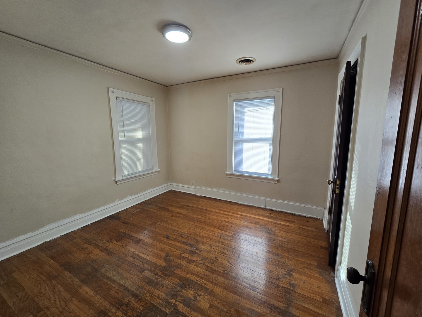 616 West Keith Avenue Waukegan, IL 60085 - Photo 6 of 19 an empty room with wooden floor and windows