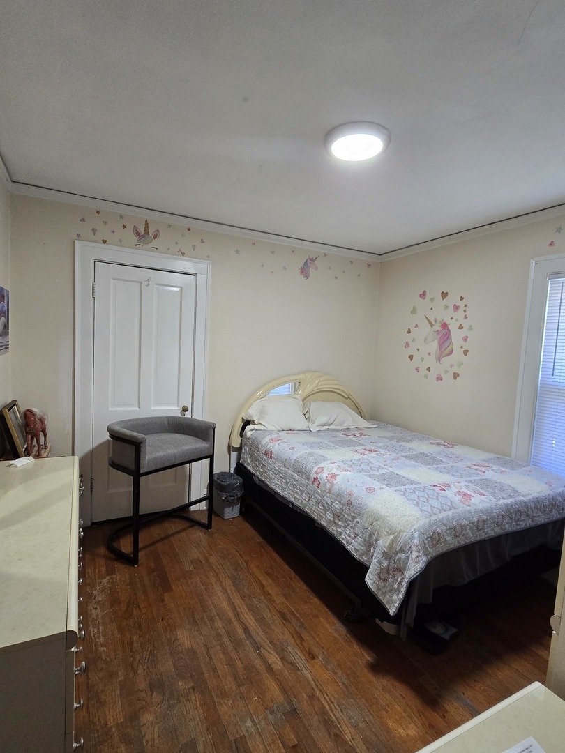 616 West Keith Avenue Waukegan, IL 60085 - Photo 8 of 19 a bedroom with a bed and a dresser next to it