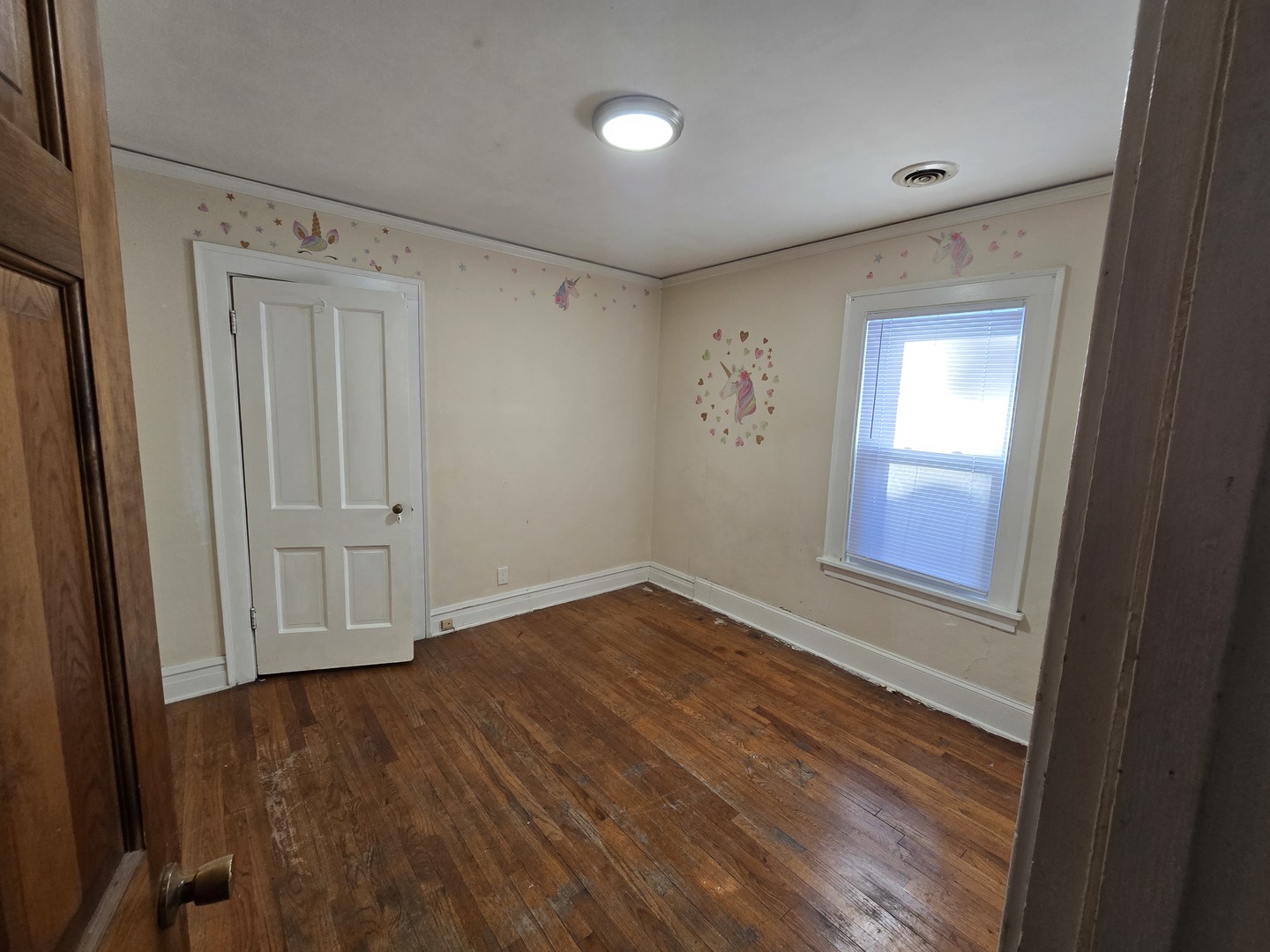 616 West Keith Avenue Waukegan, IL 60085 - Photo 9 of 19 an empty room with wooden floor and windows