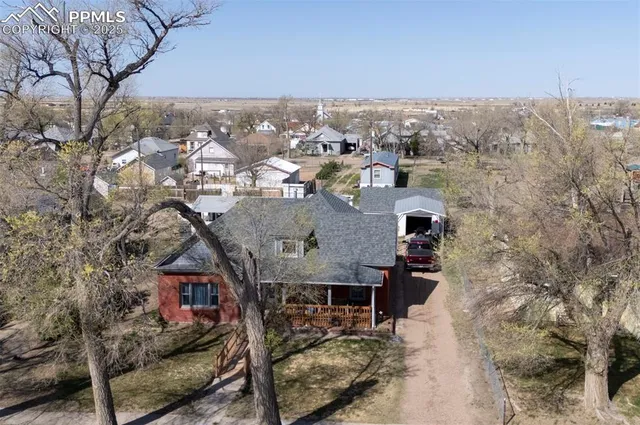 a living room with furniture and a gym machine