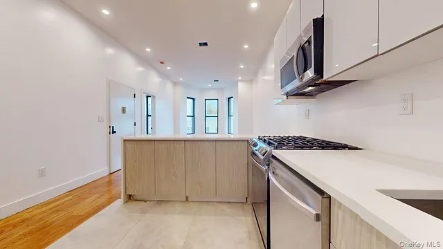 a kitchen with stainless steel appliances granite countertop a refrigerator a sink and a stove