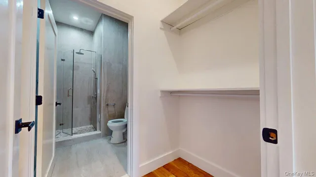 a bedroom with a bed and a potted plant