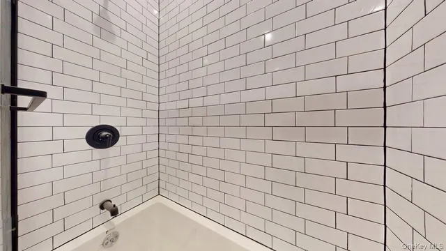 a bathroom with a toilet and a mirror