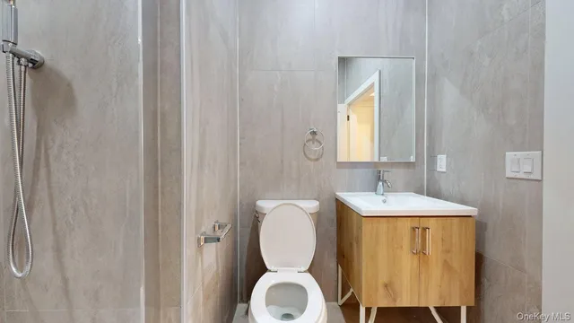 a white bed sitting in a bedroom next to a white wall