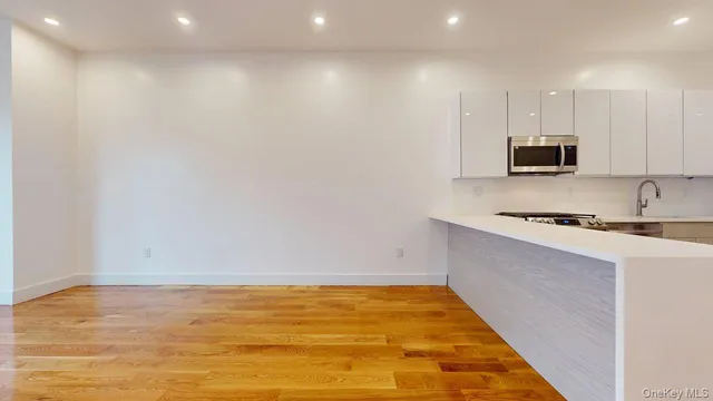 a view of kitchen with microwave and cabinets