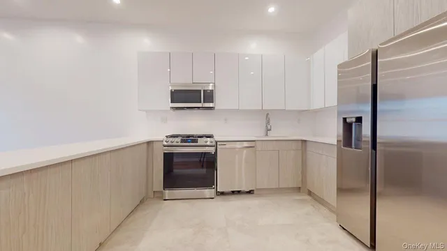 a kitchen with stainless steel appliances a stove a microwave and a refrigerator