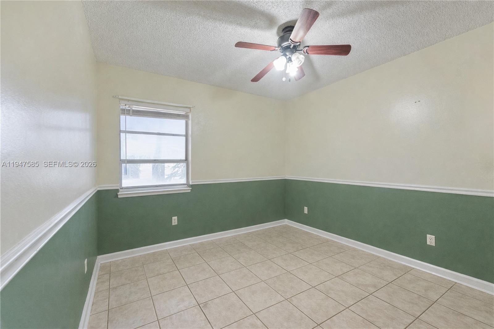 10100 Southwest 50th Court Cooper City, FL 33328 - Photo 17 of 24 an empty room with a window and a fan