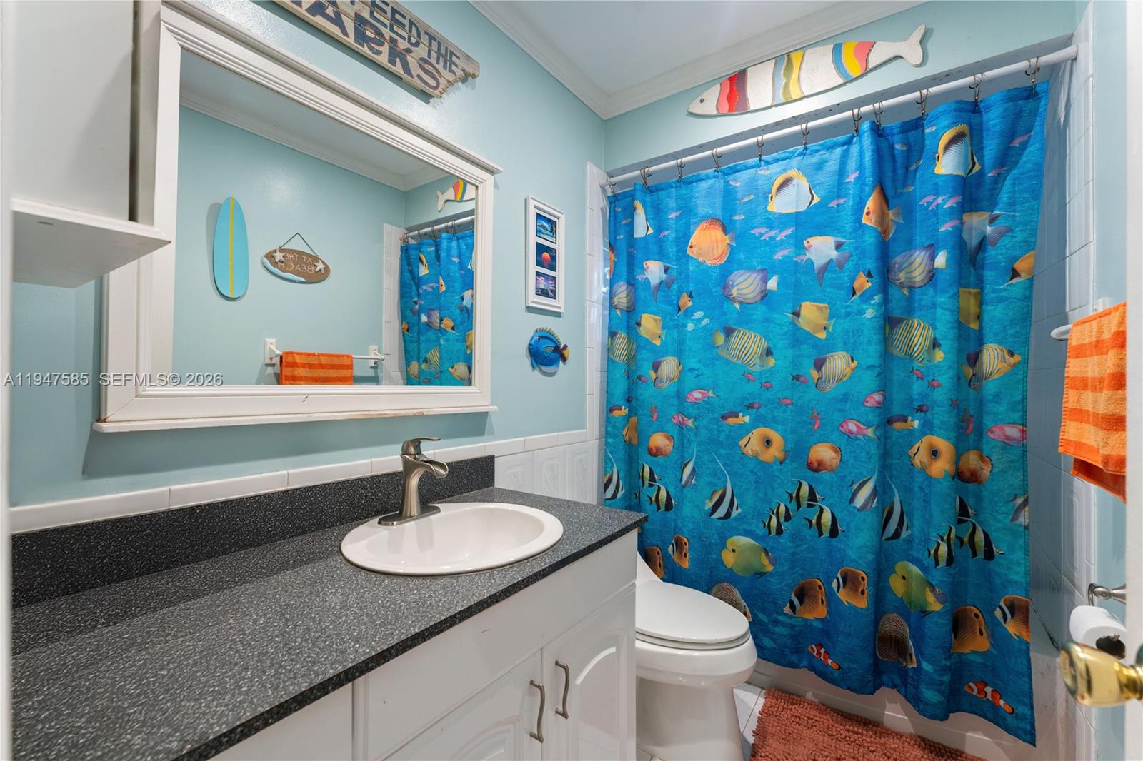 10100 Southwest 50th Court Cooper City, FL 33328 - Photo 18 of 24 a bathroom with a sink a toilet and a mirror