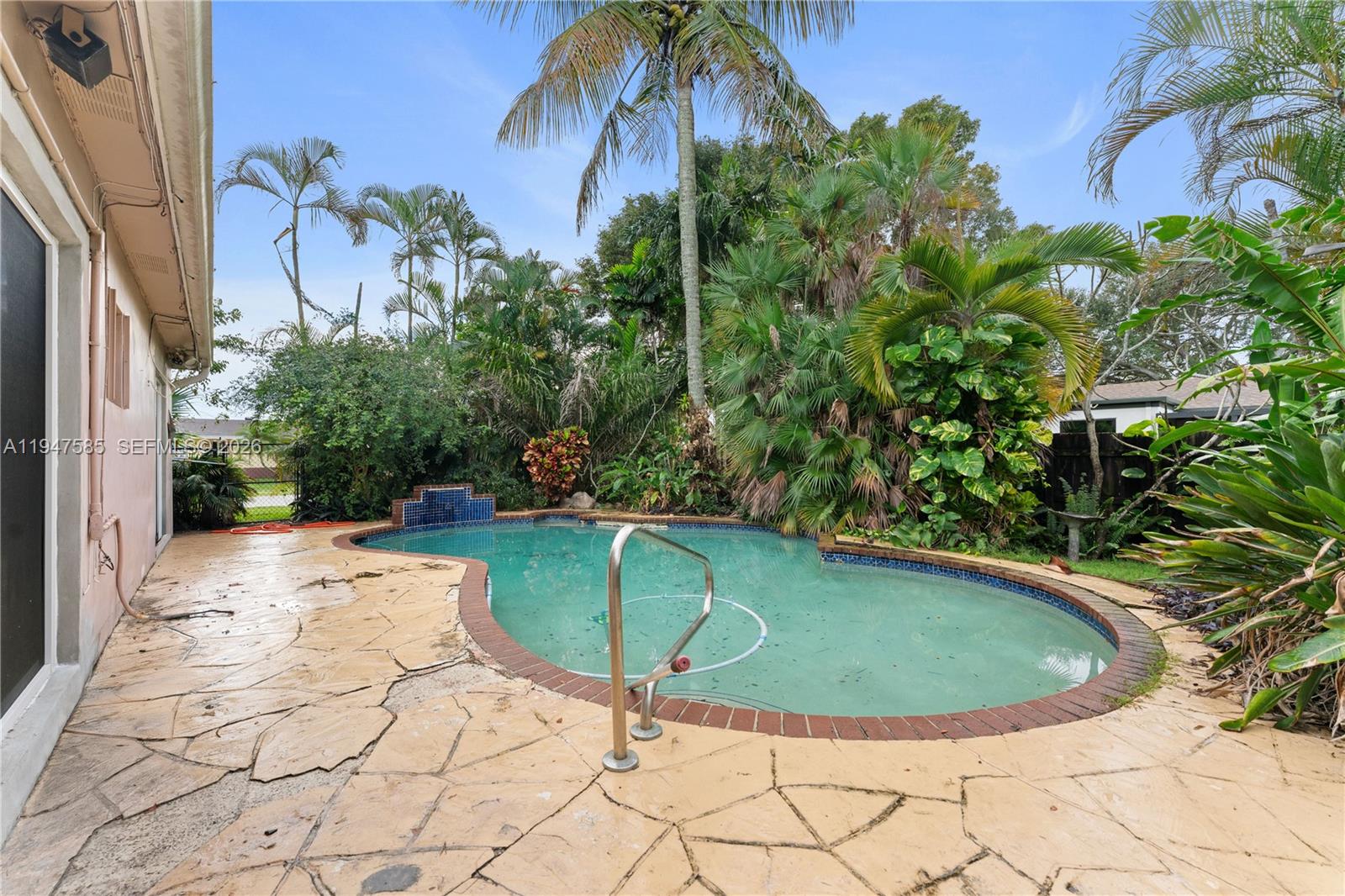 10100 Southwest 50th Court Cooper City, FL 33328 - Photo 22 of 24 a view of a swimming pool in a backyard