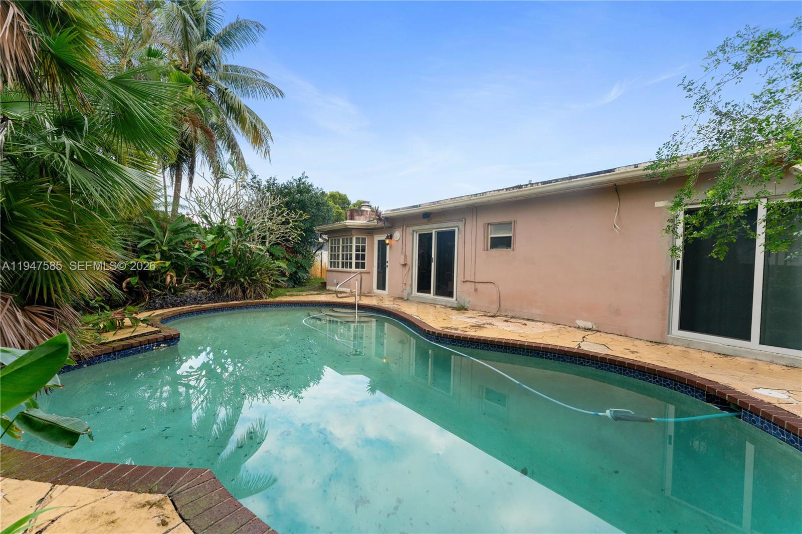 10100 Southwest 50th Court Cooper City, FL 33328 - Photo 24 of 24 a swimming pool with patio outdoor seating and yard